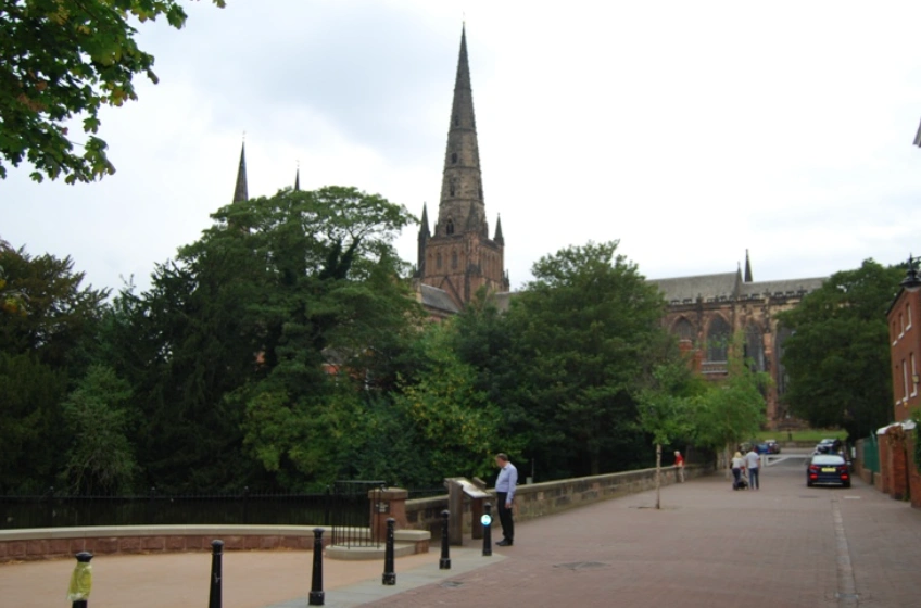 Park and part of a street in a city in the UK