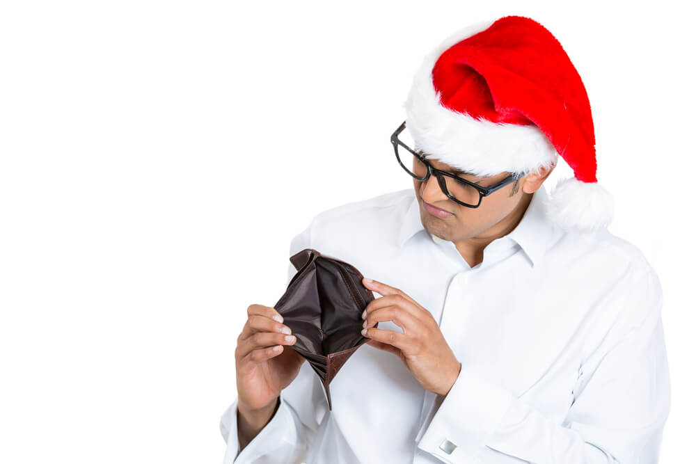 man with empty wallet at christmas