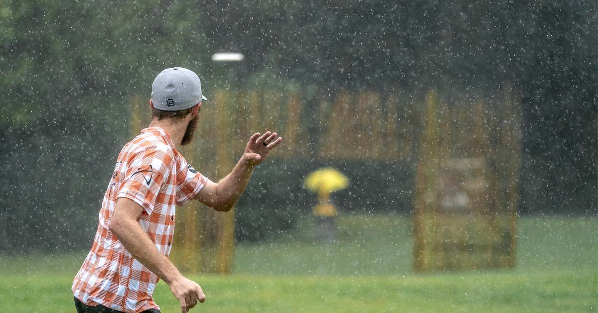 Chris Dickerson watching the flight of his disc in heavy rain