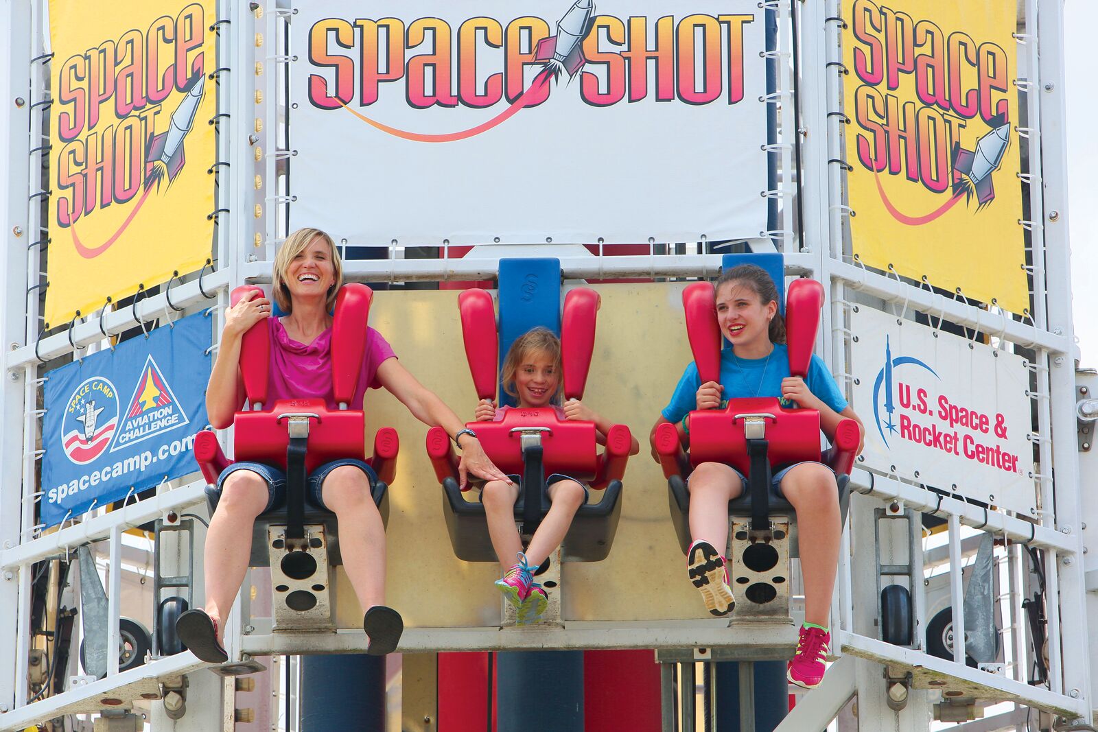 Family enjoying the Space Shot amusement park ride