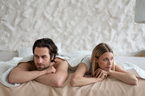 Man and woman in bed frustrated
