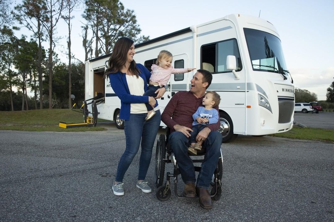 young family outside of wheelchair accessible RV