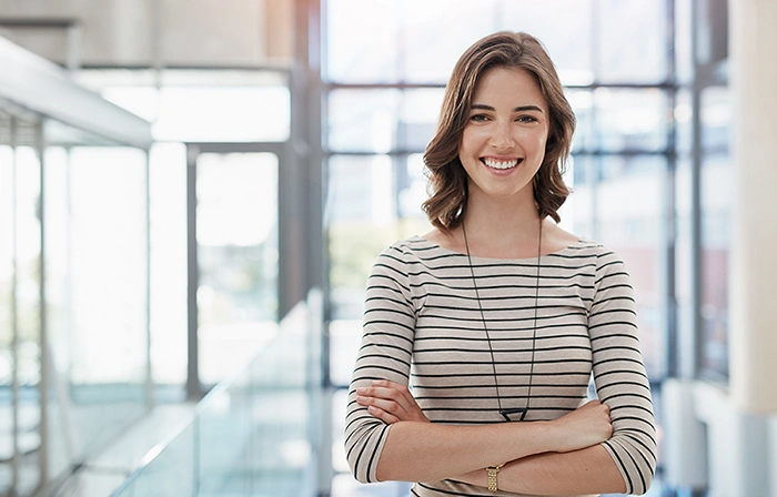 lady with her arms crossed smiling