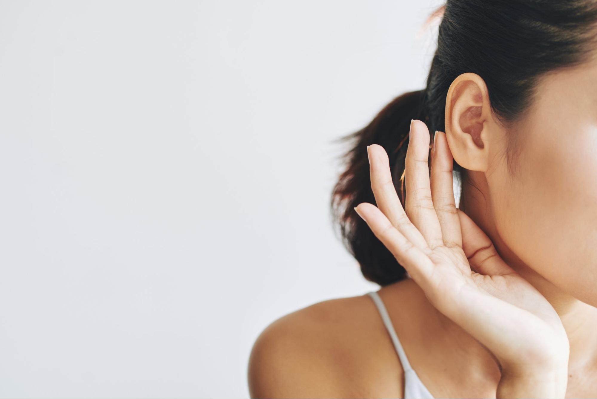 girl holding her ear