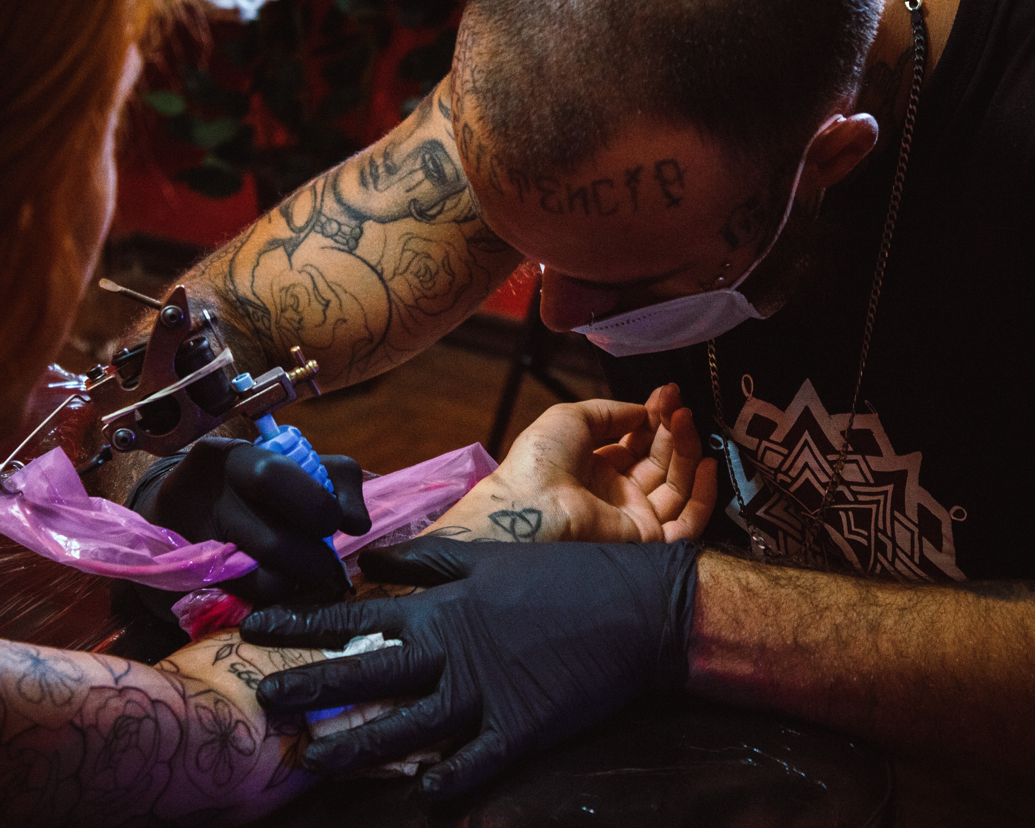 tattooing with mask on