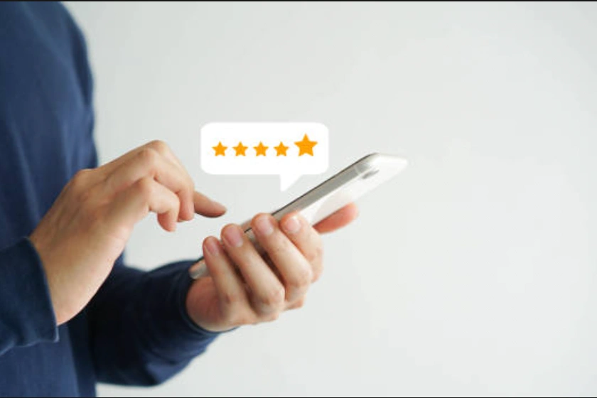 Hands selecting a 5 star review on a phone