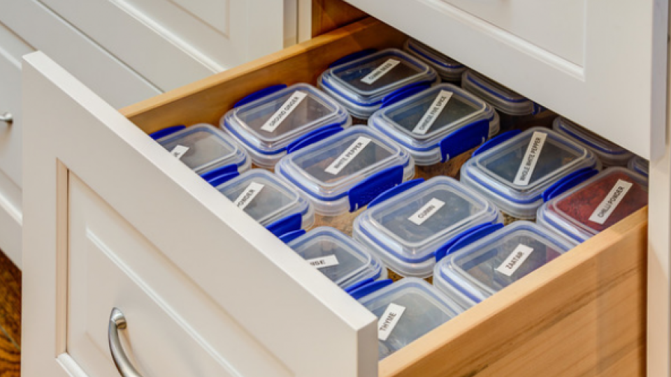 Open kitchen cabinet with storage containers