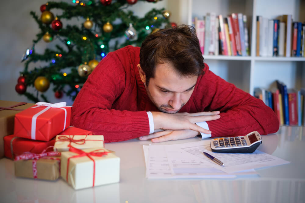 A man feels overwhelmed by his holiday debt