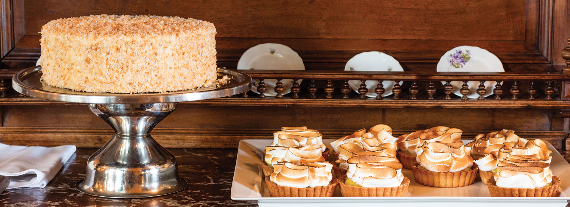 A shot of coconut cake and miniature pies.