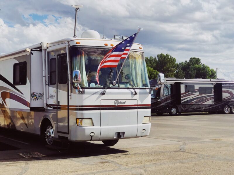 A rv with a flag in the front