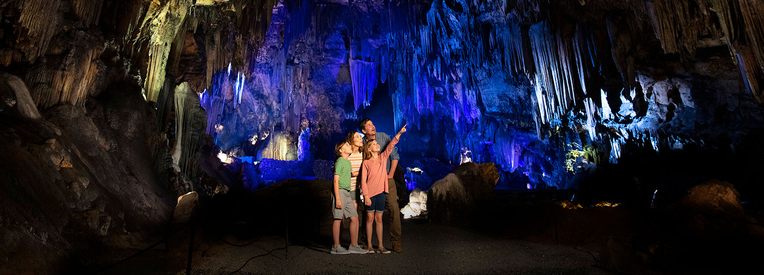 A family standing in the middle of desoto caverns.