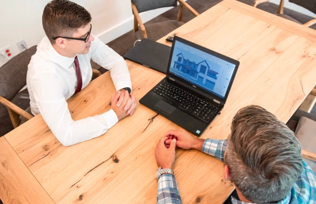 Architects sitting in an office looking at laptop