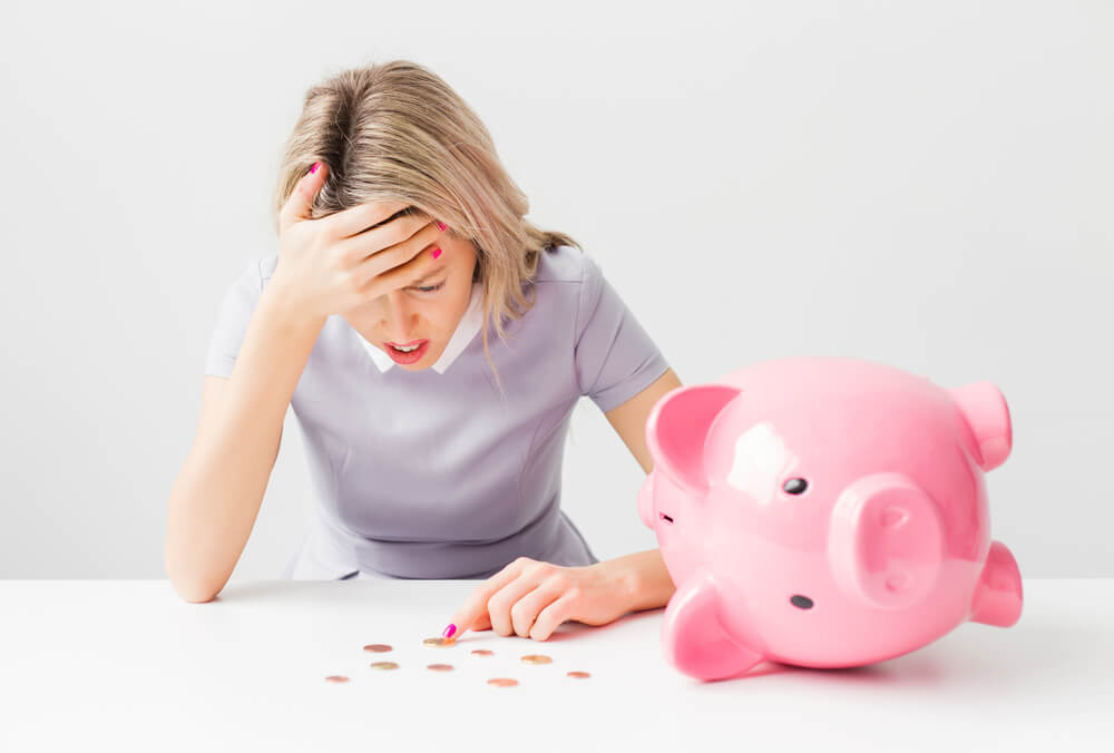 stressed over empty piggy bank