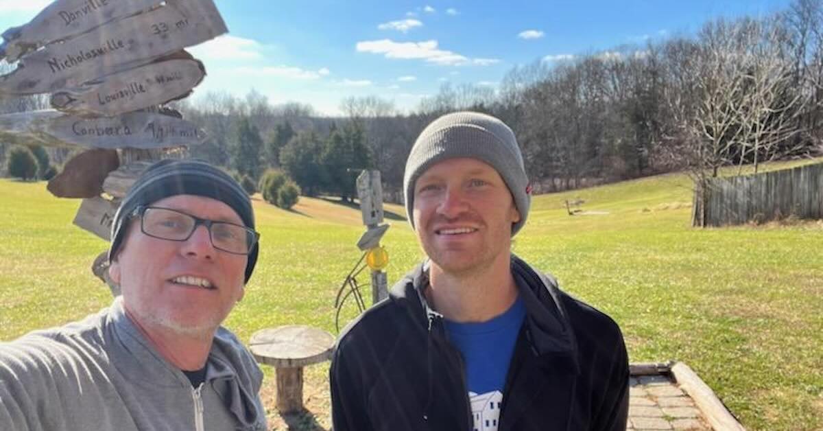 Two men taking a selfie outdoors on a sunny day 