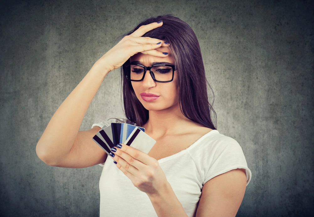 Woman with multiple credit cards in her hand