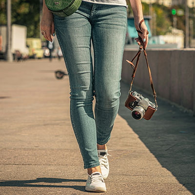 Woman walking with camera.