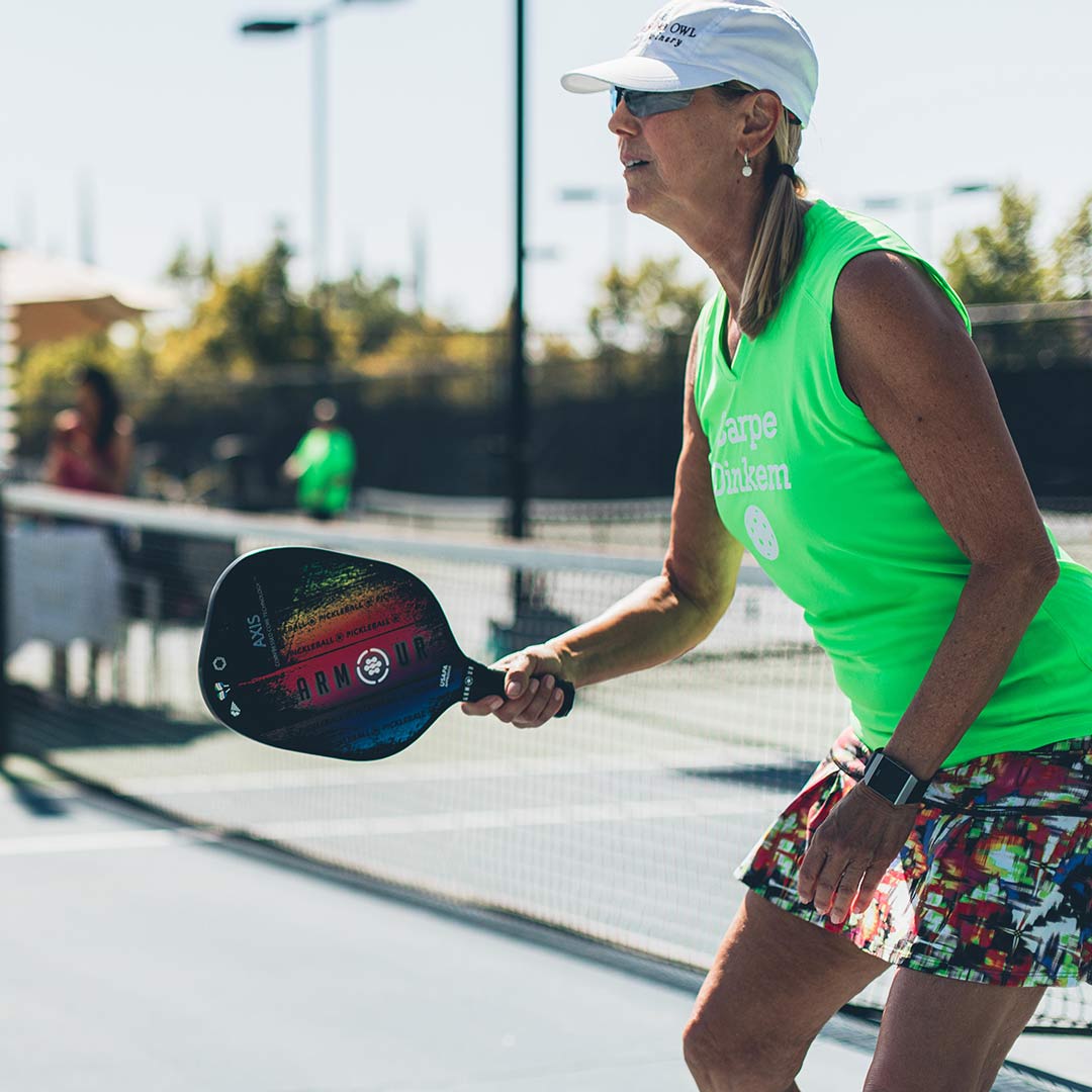 Women playing pickleball outdoors