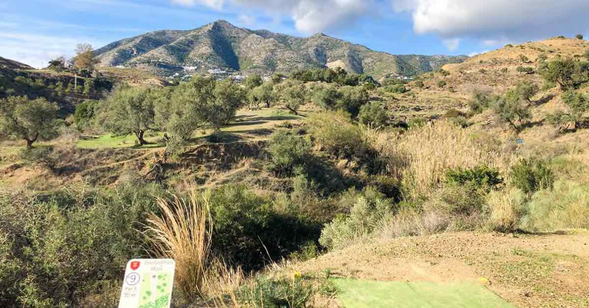 A disc golf tee pad and a lovely view of mountains