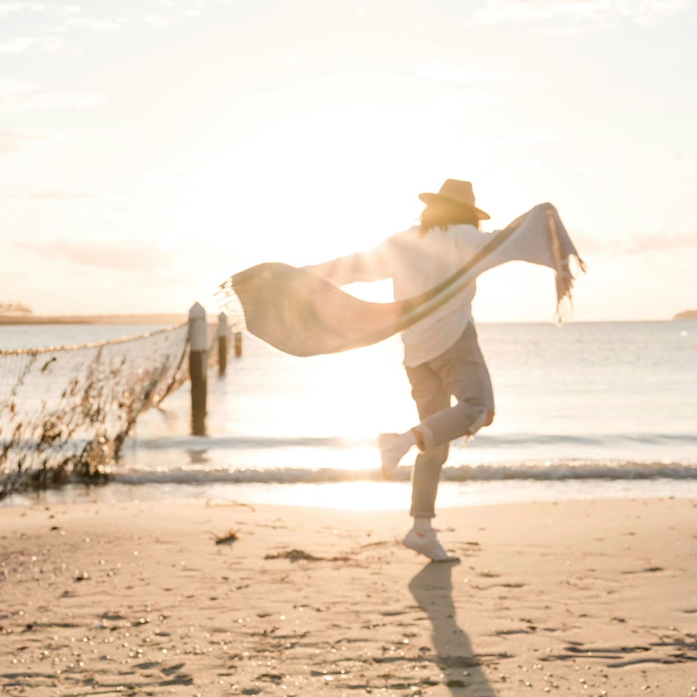 Man Enjoying Life on Beach.webp