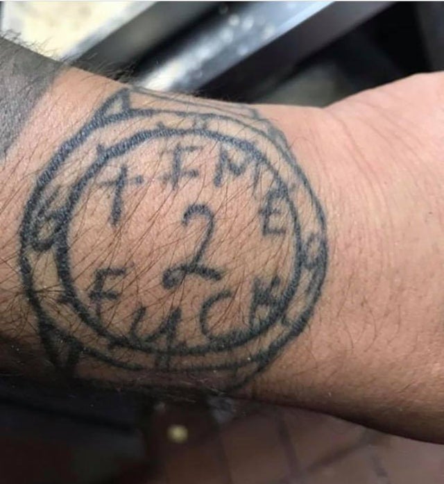 awful tattoo of watch in wrist