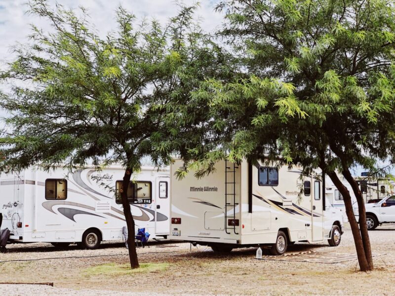 A group of rvs parked in a parking lot