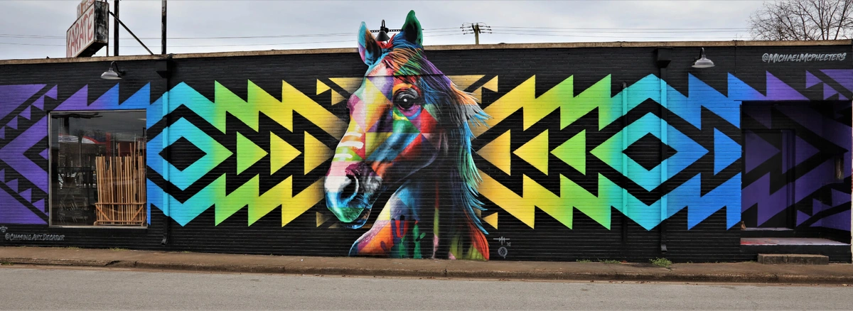 Multi-colored graffiti of a horse on the side of a building