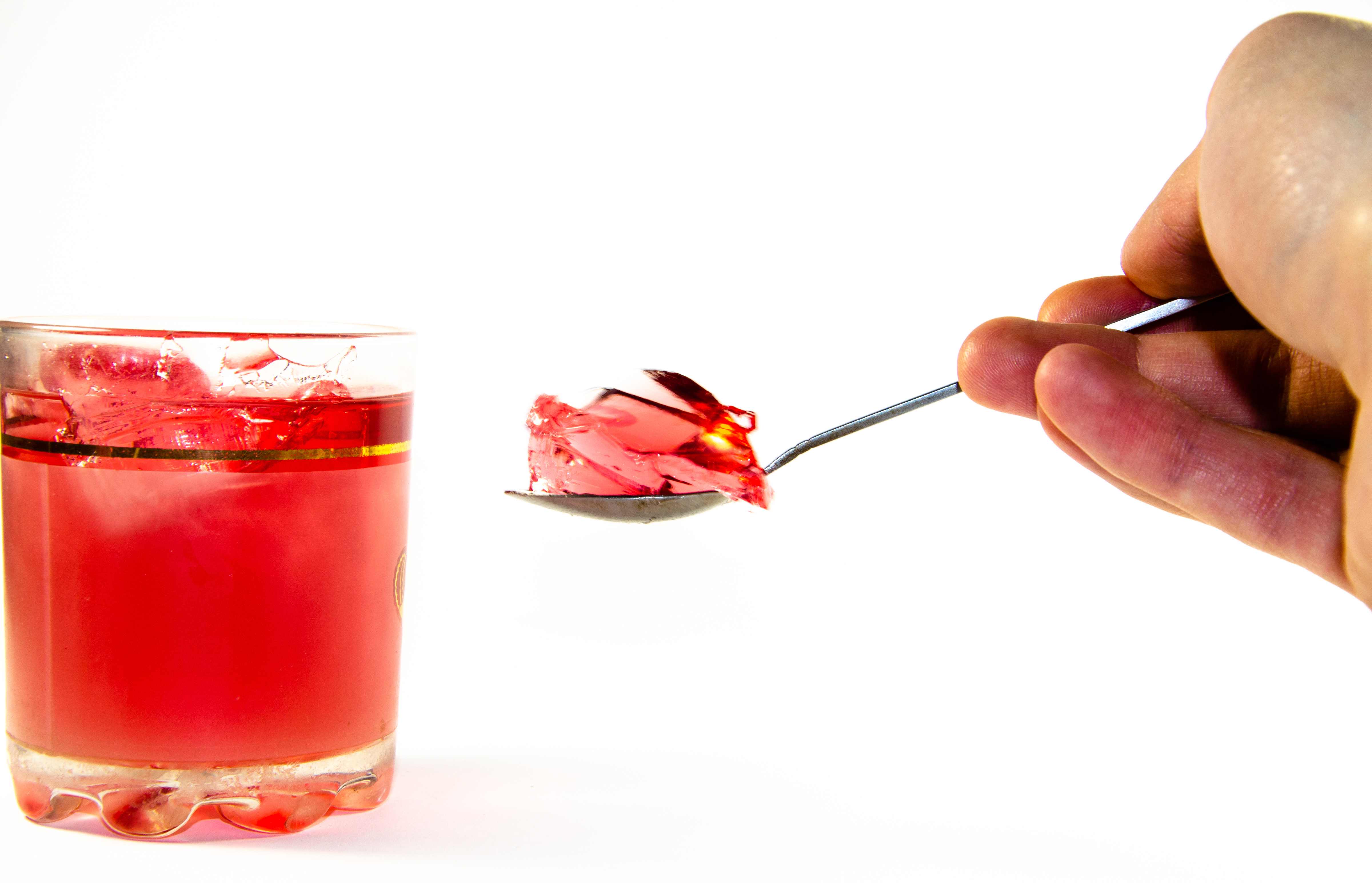 Cup of Jello Held By Spoon