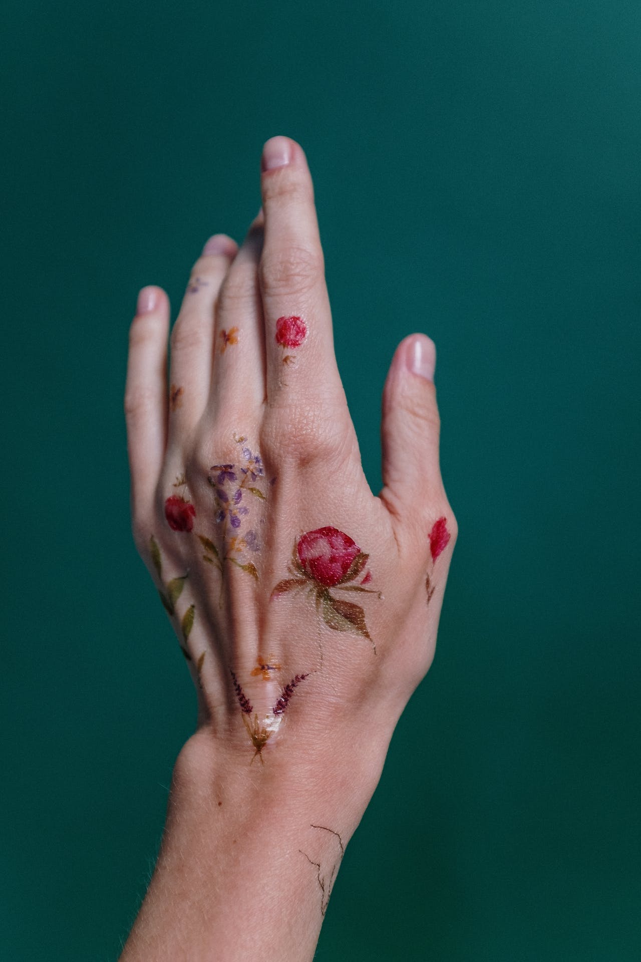 woman hand with flower temporary tattoo