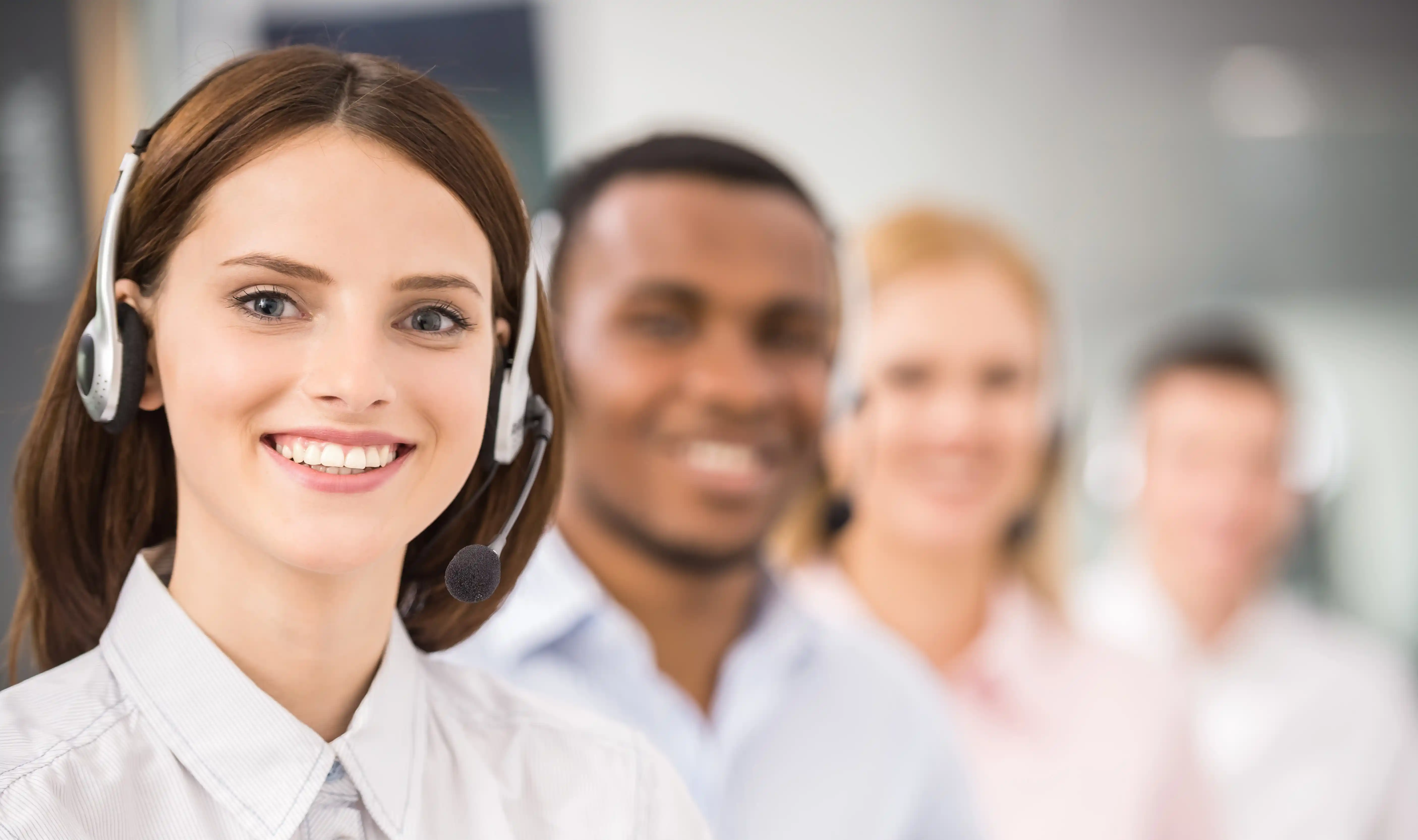Diverse call center team with headsets representing culturally aligned customer support in managed teams