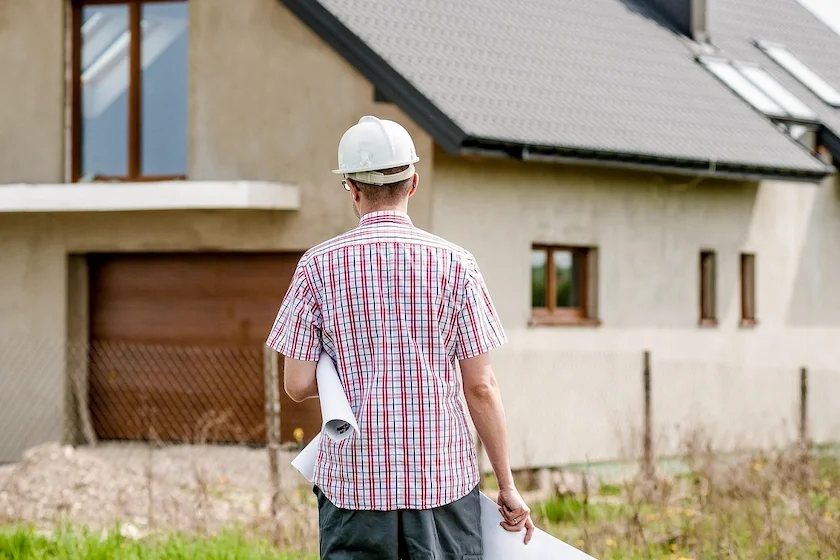 Architect walking toward a house project