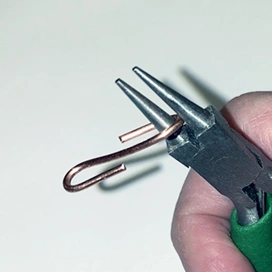 Pliers wrapping an S hook clasp