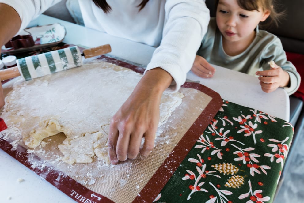 mom and daughter making cookies during Christmas