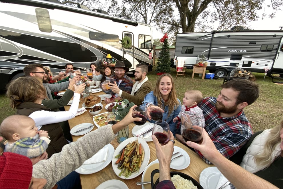 group of friends eating thankgiving dinner at RV campground