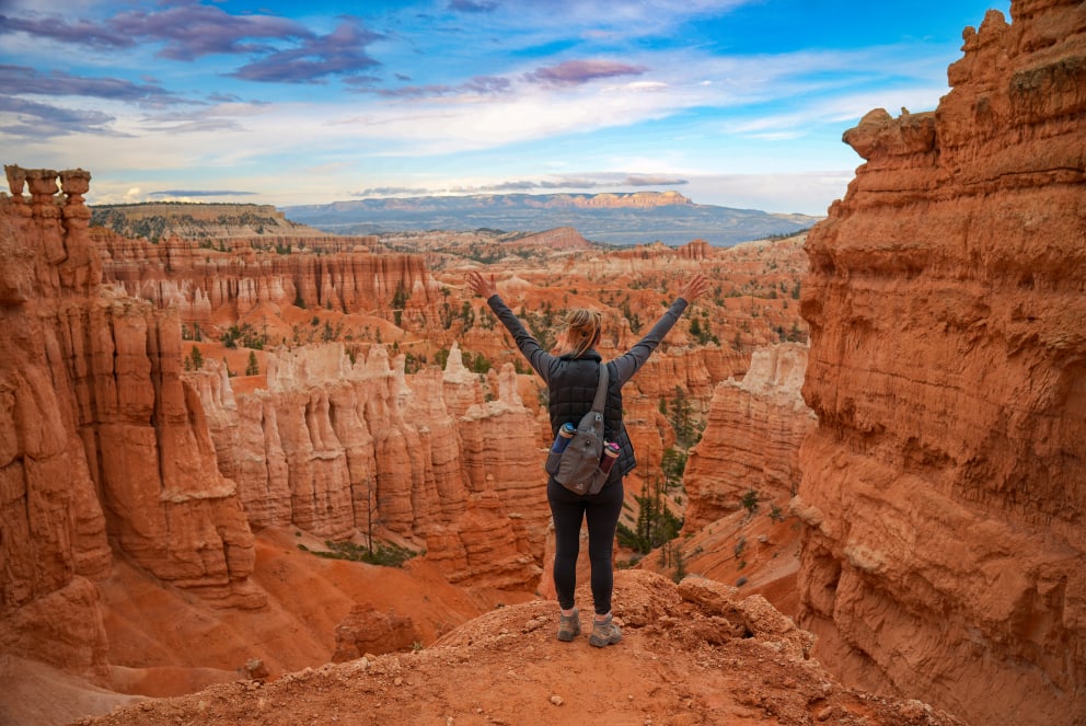 woman on cliff in desert