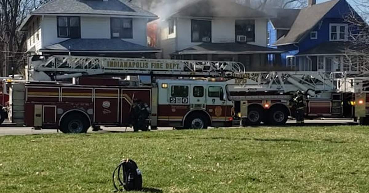 Fire trucks in front of a burning house