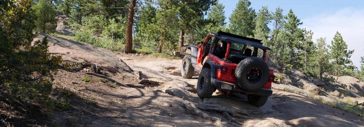 Jeep going up Solitude Creek offroad trail near Loveland, CO