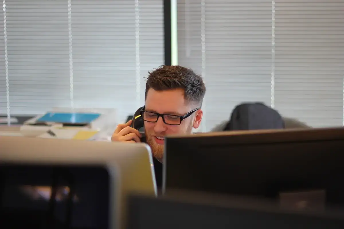 A man learns sales call tips to engage customers in his office.