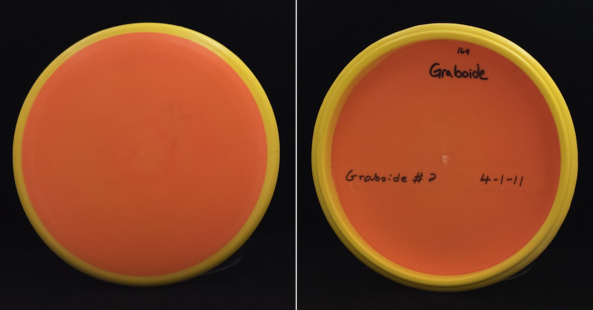 An orange disc with yellow rim seen from top and bottom