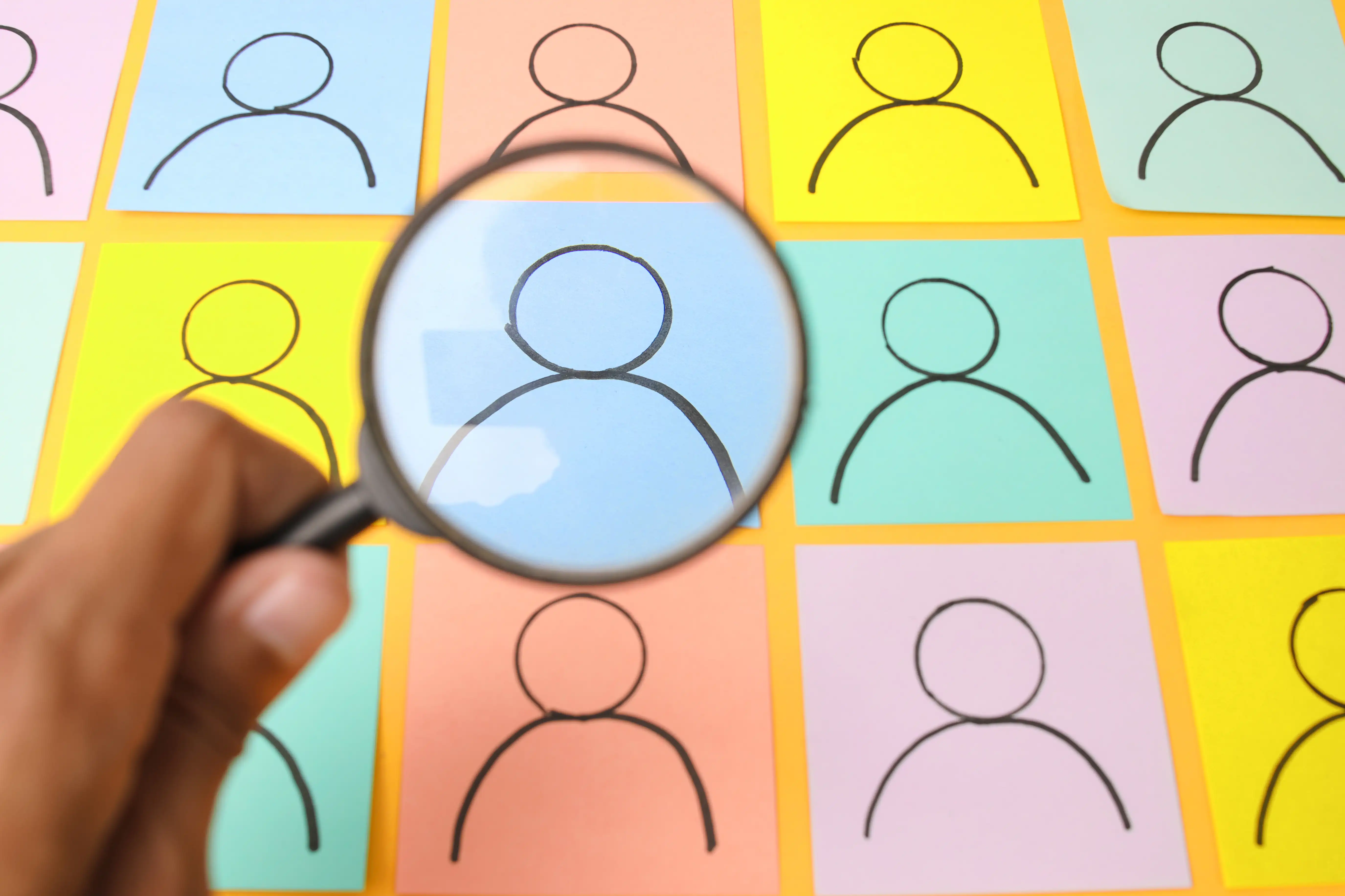 Magnifying glass selecting a candidate from a talent pool