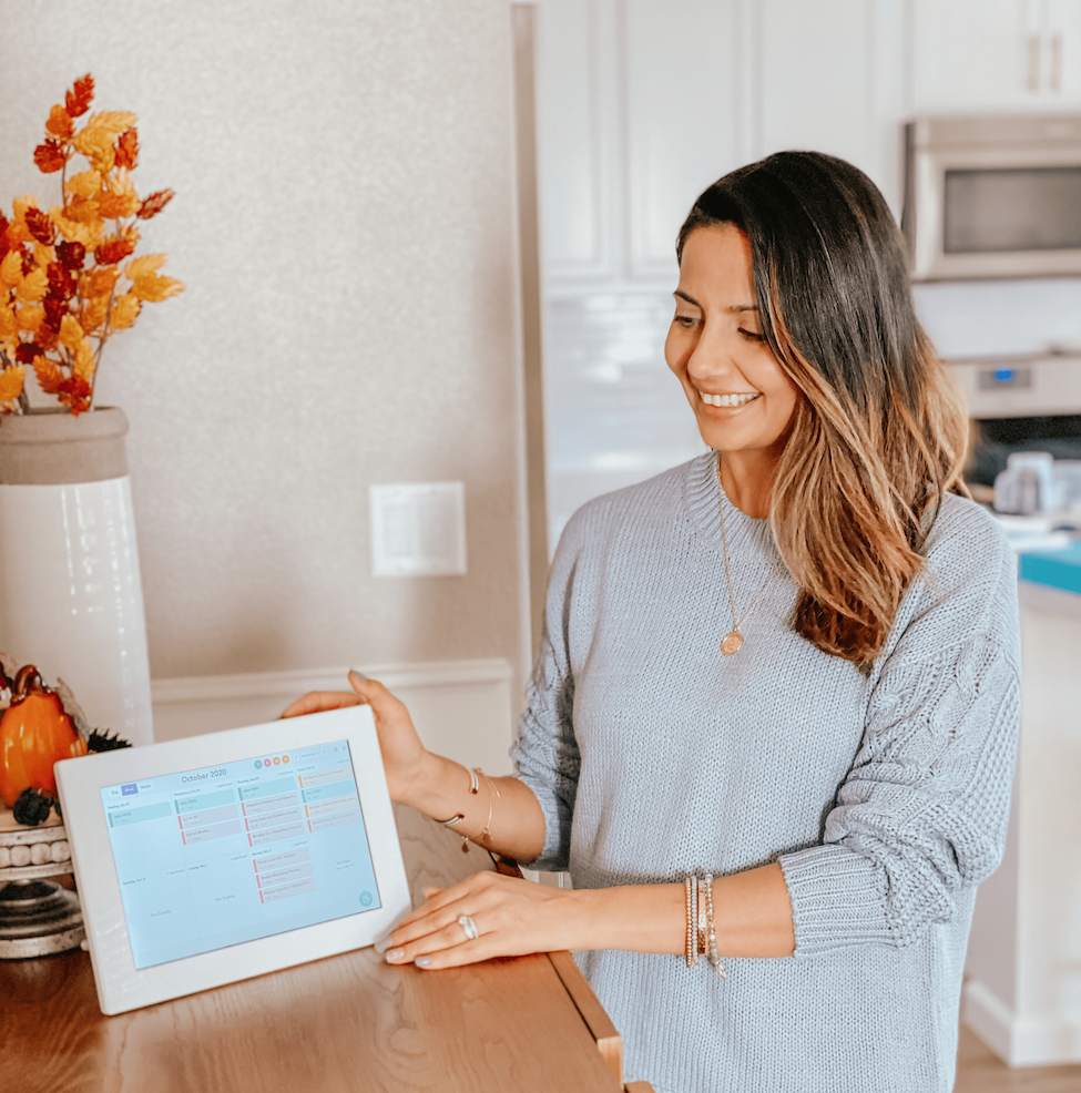 Mom with digital calendar displaying all her events in one place