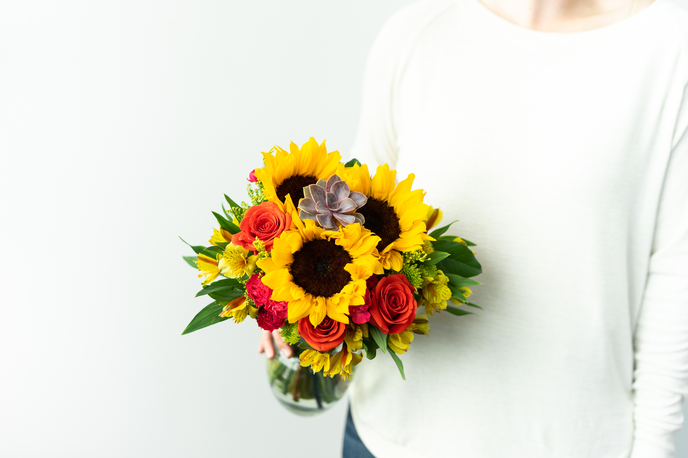 Woman Holding Sunflower and Succulent Bouquet