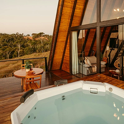 Terrace of the Cabana Raposo Inn with a Table and a Jacuzzi at Sunset.