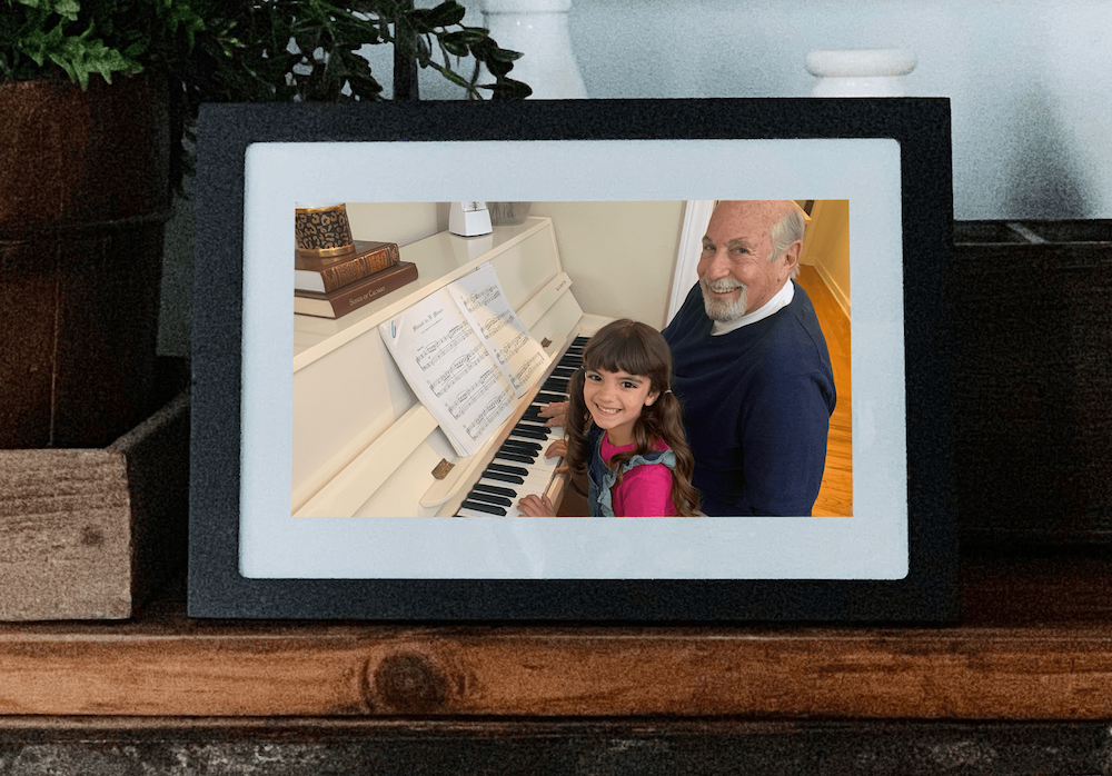 Grandpa and granddaughter playing piano on digital photo frame