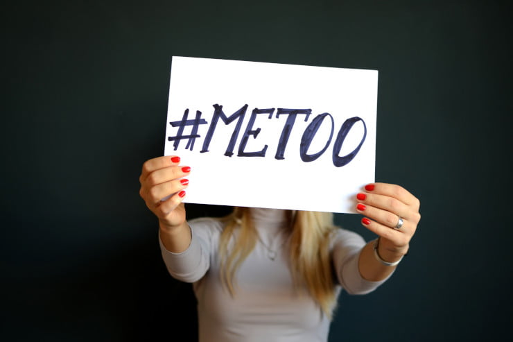 woman holding #metoo sign - social movement content creation