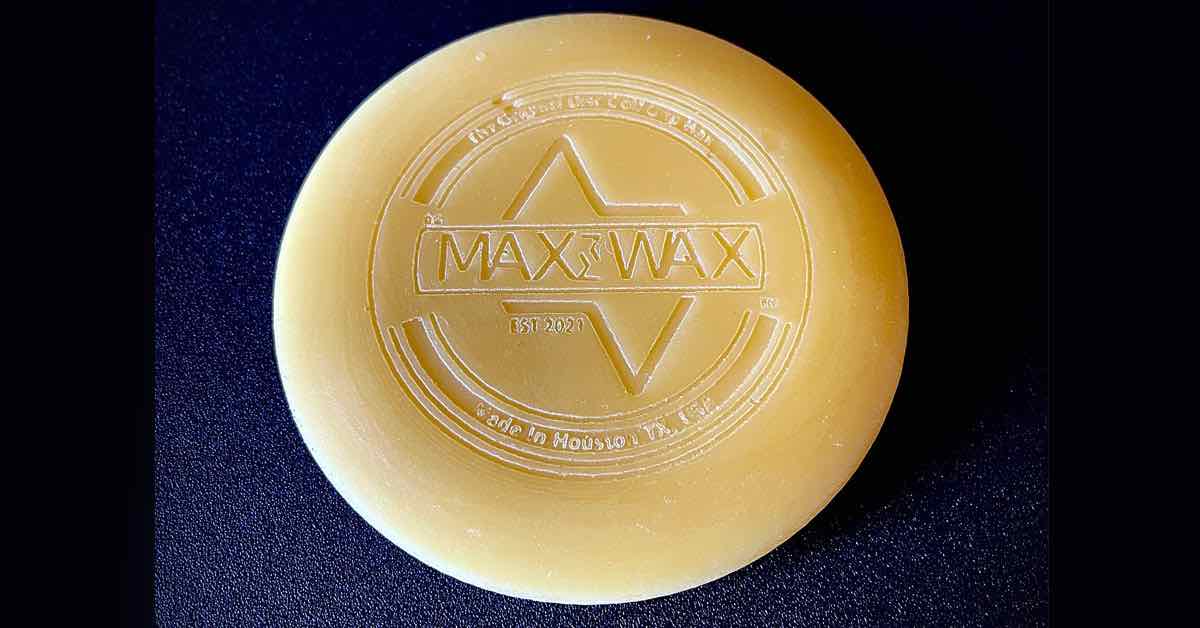 A round wax object with "Max Wax" prominently engraved in the middle