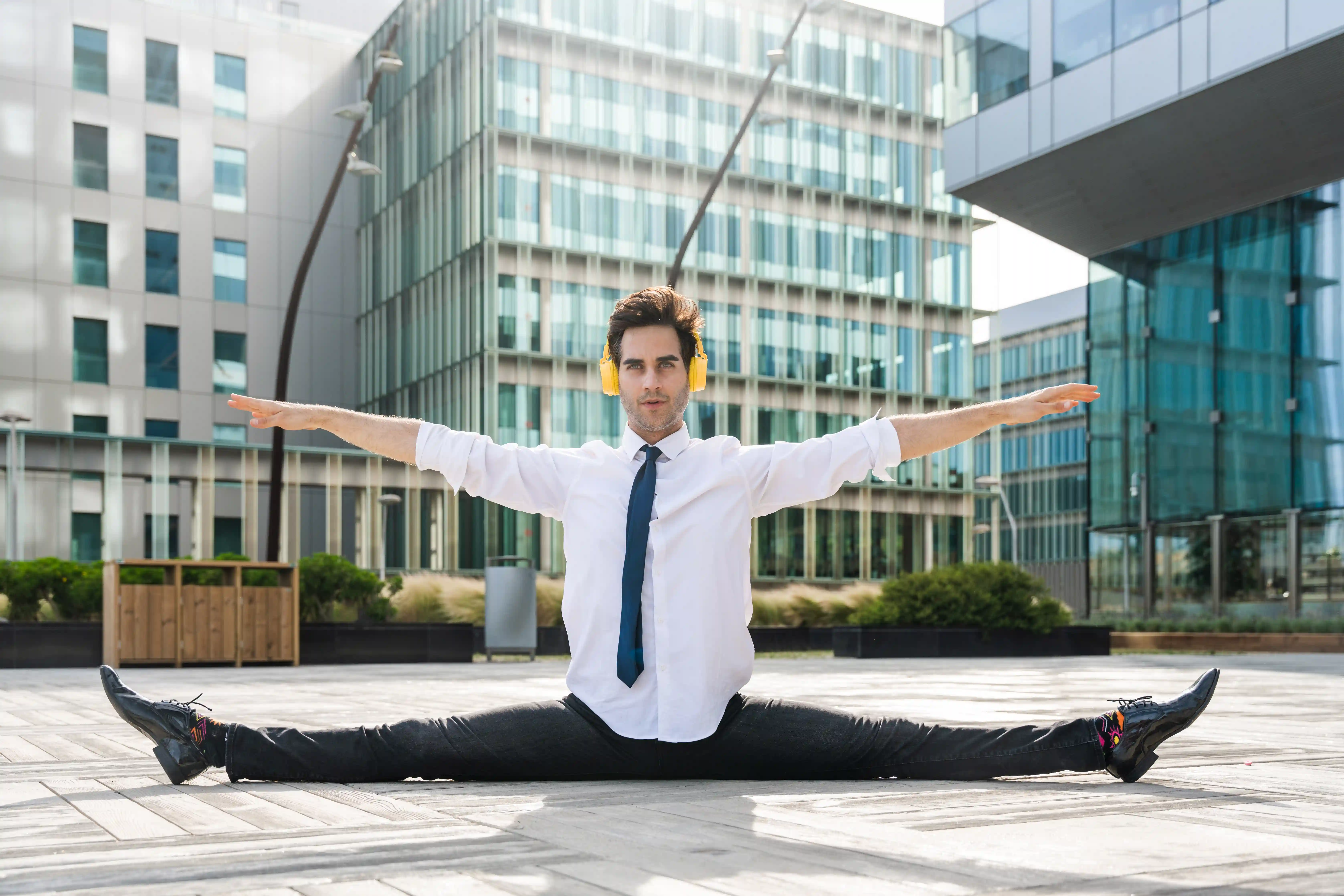 Flexible businessman doing split representing business agility and operational elasticity