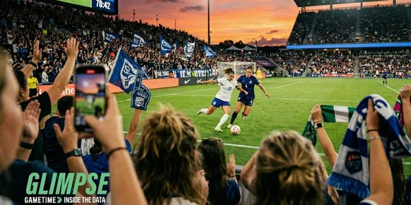 Women's soccer fans in front of players in a match