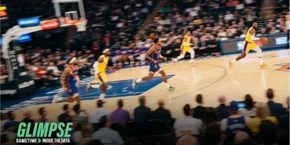 A basketball court with players surrounded by a crowd