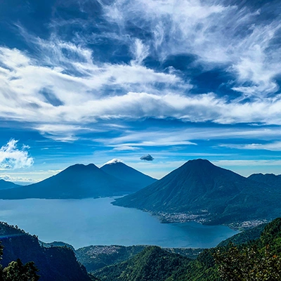 mountains under white clouds and blue sky