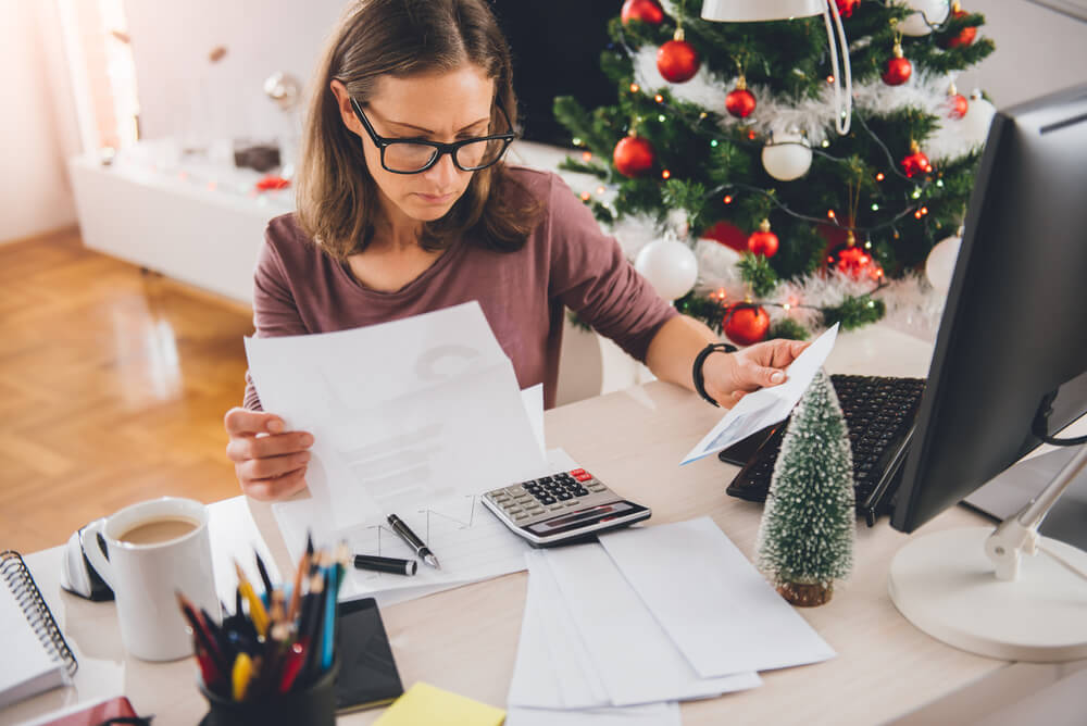 woman stressed over holiday debt